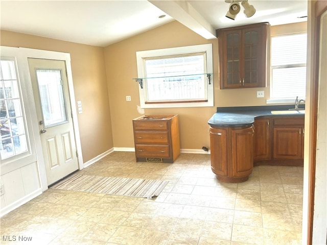 kitchen with vaulted ceiling, sink, and ceiling fan