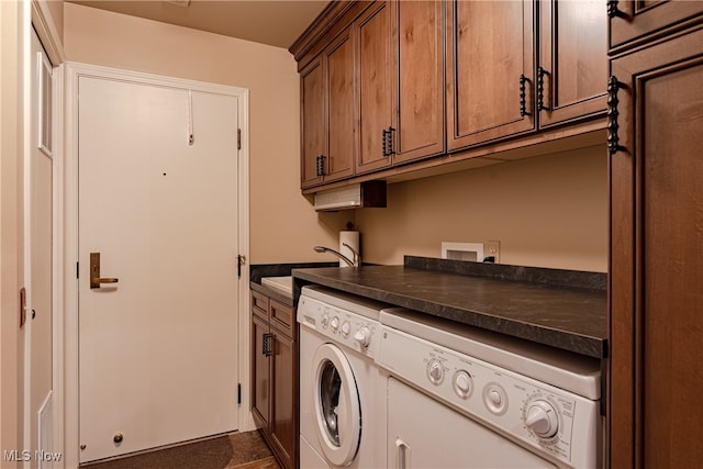 laundry room featuring cabinets, washer and clothes dryer, and sink