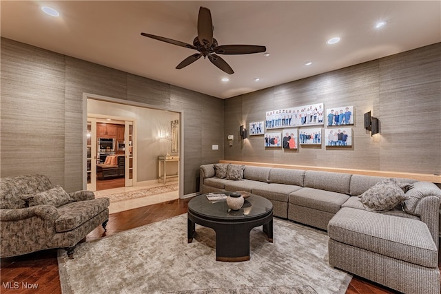 living room with wood-type flooring and ceiling fan