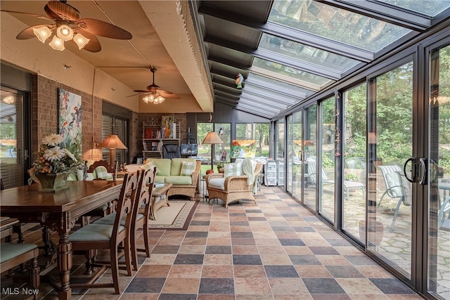 sunroom / solarium with ceiling fan, plenty of natural light, and lofted ceiling