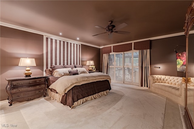 bedroom featuring ceiling fan, ornamental molding, and light colored carpet