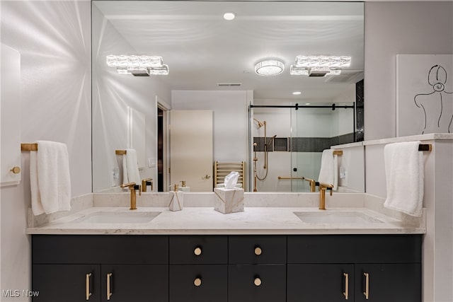 bathroom with vanity and a shower with shower door