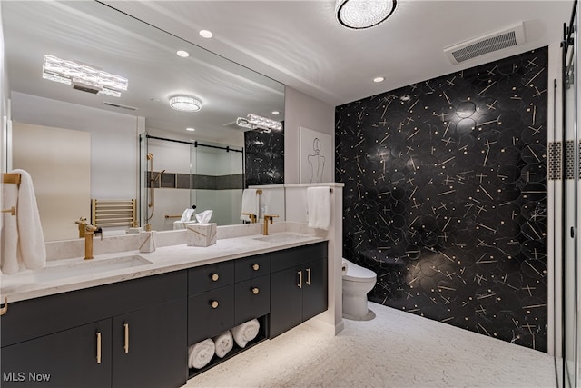 bathroom with toilet, a shower, vanity, and tile walls