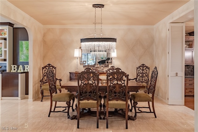 dining space featuring a chandelier and ornamental molding