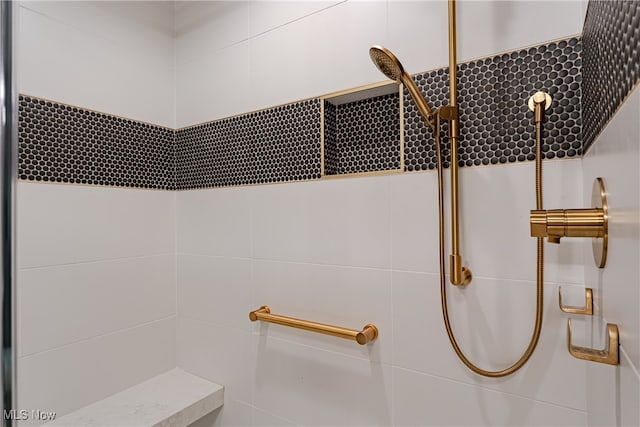 bathroom featuring walk in shower and backsplash