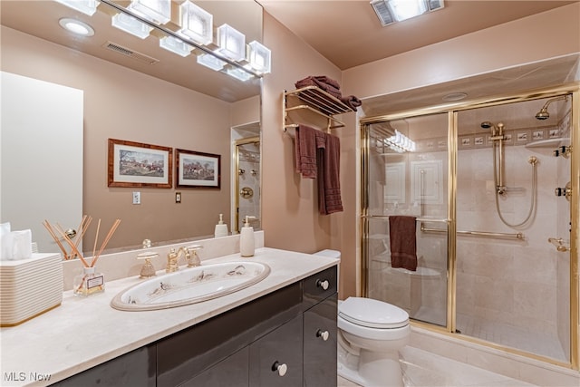 bathroom featuring walk in shower, vanity, and toilet