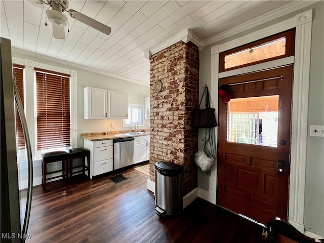 kitchen with ceiling fan, ornamental molding, white cabinetry, appliances with stainless steel finishes, and dark hardwood / wood-style floors