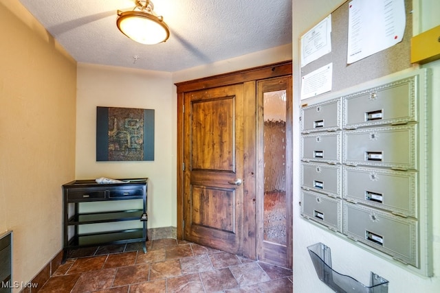 foyer entrance featuring a textured ceiling