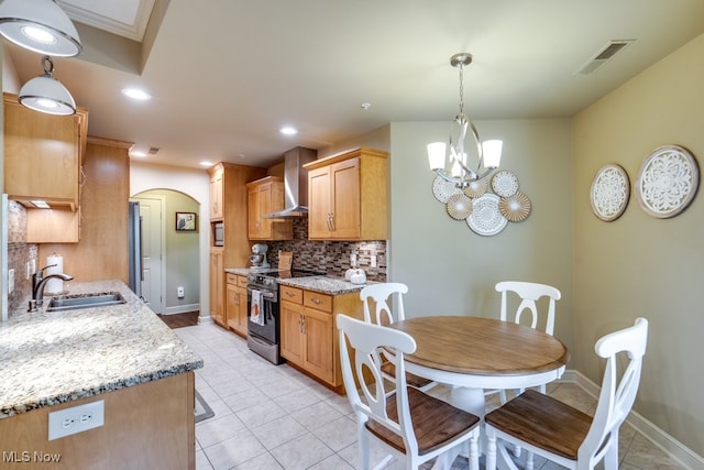 kitchen with wall chimney range hood, an inviting chandelier, sink, stainless steel electric range oven, and backsplash