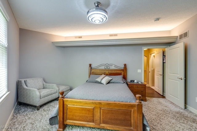 bedroom featuring hardwood / wood-style floors and multiple windows