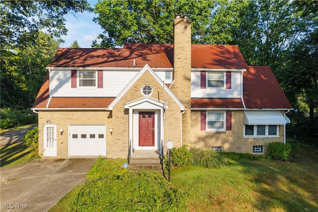 view of front of home featuring a garage and a front lawn