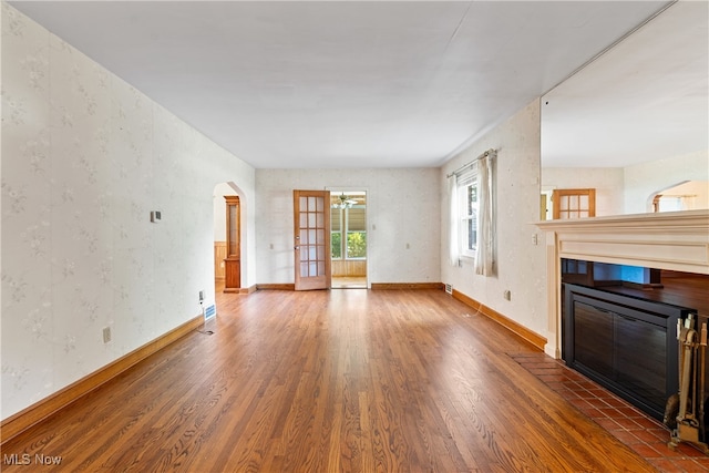 unfurnished living room featuring dark hardwood / wood-style flooring