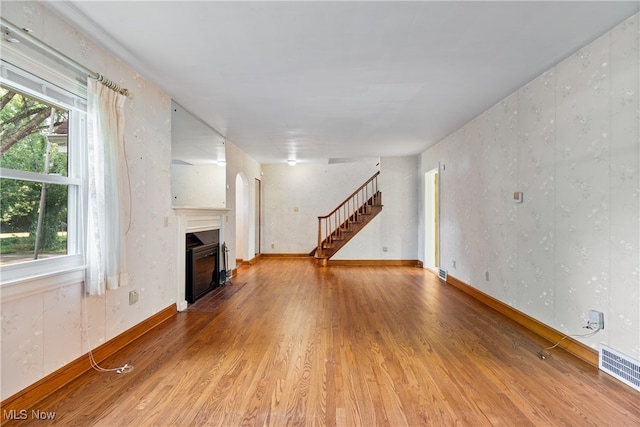 unfurnished living room featuring hardwood / wood-style floors