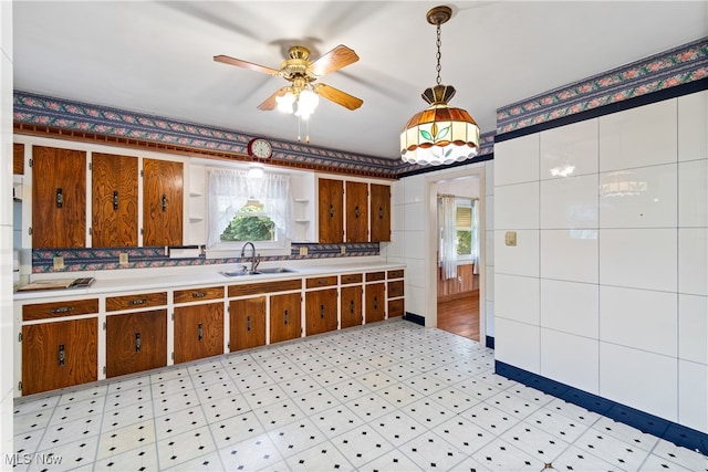 kitchen with pendant lighting, ceiling fan, sink, and a healthy amount of sunlight