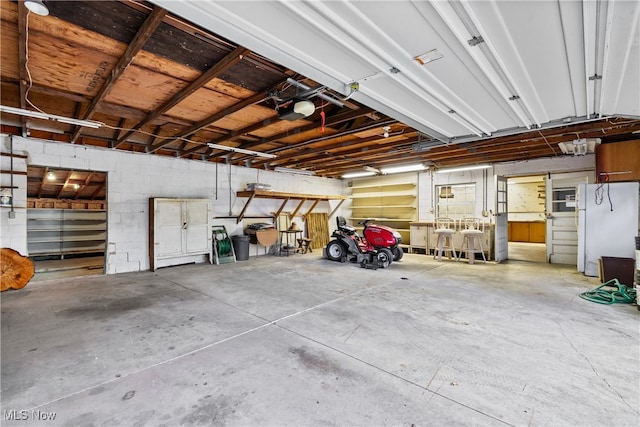 garage featuring a garage door opener and white fridge