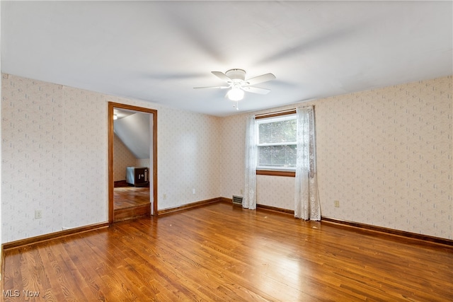 spare room with wood-type flooring and ceiling fan