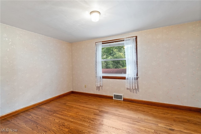 empty room with wood-type flooring