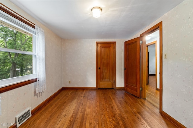 empty room with hardwood / wood-style floors