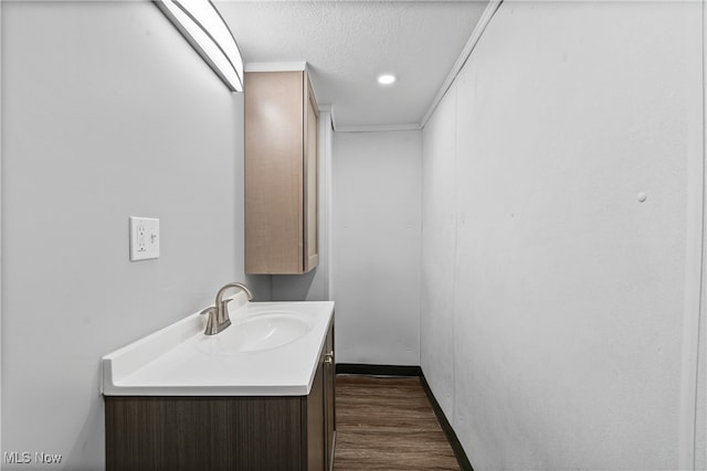 bathroom featuring vanity, hardwood / wood-style floors, and a textured ceiling