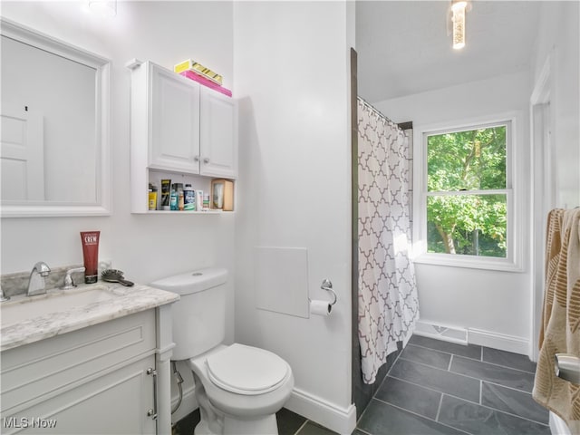 bathroom featuring tile patterned floors, vanity, and toilet