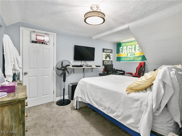 bedroom featuring a textured ceiling and carpet flooring