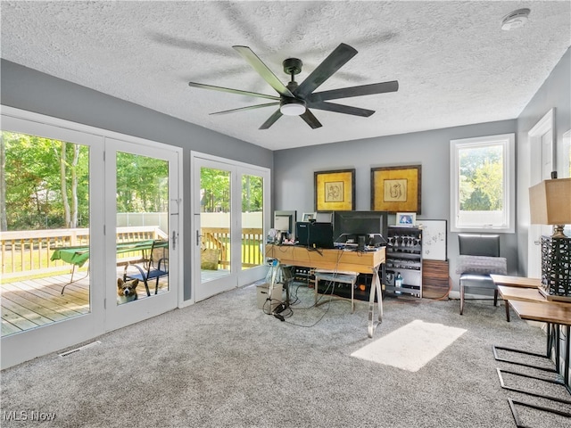 office space featuring ceiling fan, a textured ceiling, and carpet