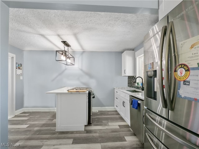 kitchen with stainless steel appliances, dark wood-type flooring, sink, and white cabinetry