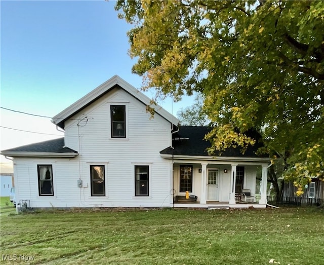 rear view of house with a yard