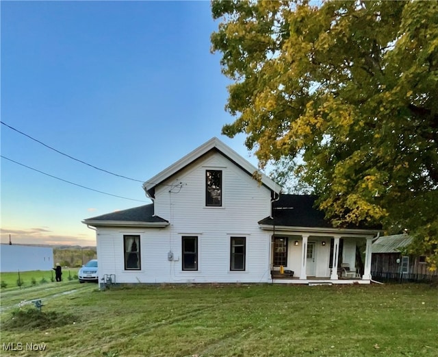 view of front of house featuring a yard and covered porch