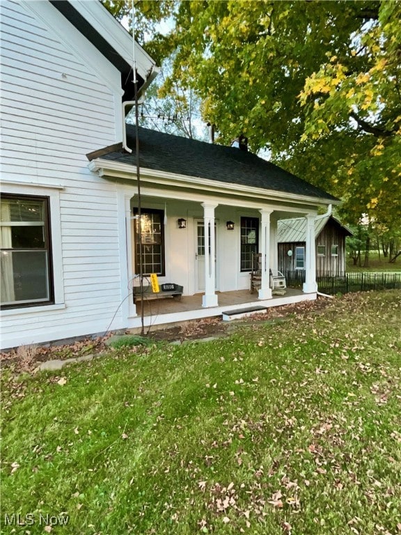 exterior space with a lawn and covered porch