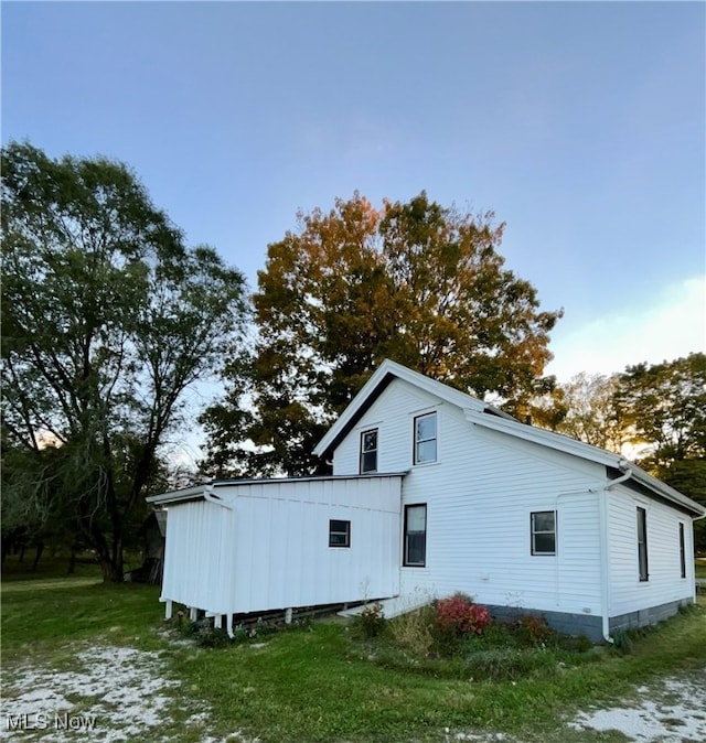 view of side of home featuring a lawn