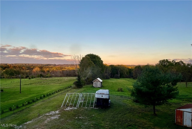 yard at dusk with a rural view