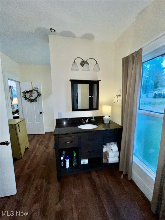 bathroom featuring vanity, a textured ceiling, hardwood / wood-style flooring, and a healthy amount of sunlight