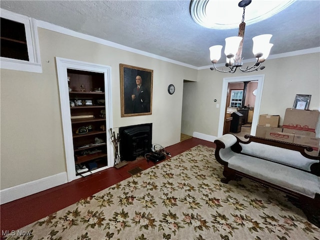 living room featuring ornamental molding, a chandelier, and a textured ceiling