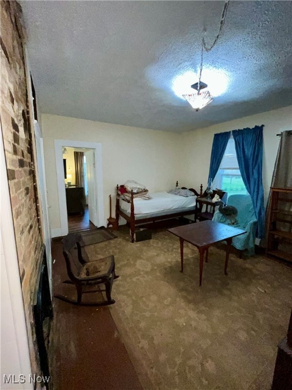 carpeted bedroom featuring a textured ceiling