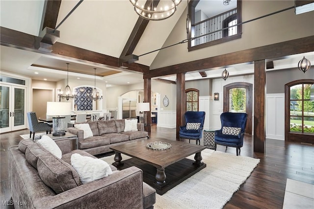 408 Sharon Falls Dr, Wadsworth, OH 44281 - living area with a high ceiling, a decorative wall, arched walkways, a chandelier, and dark wood-style floors