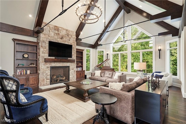 sunroom with a stone fireplace, lofted ceiling with beams, and a chandelier