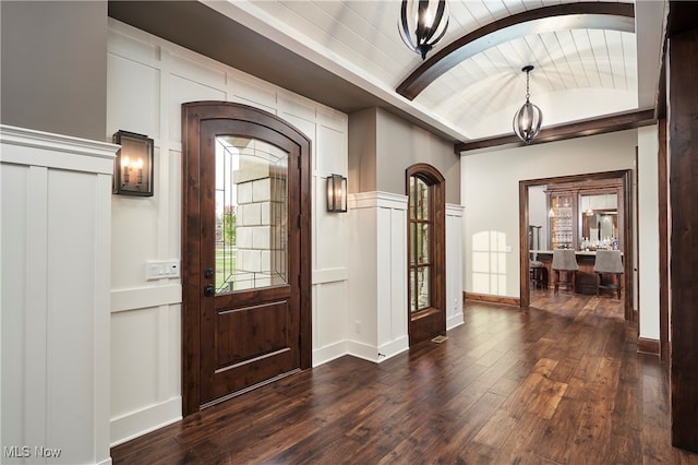 entryway featuring dark wood-type flooring, brick ceiling, and vaulted ceiling