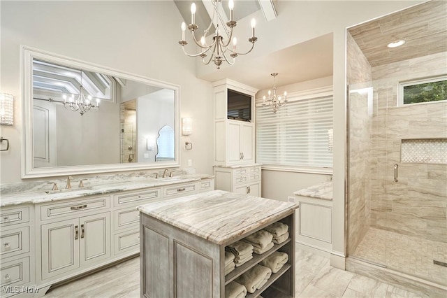 bathroom with an inviting chandelier, vanity, and walk in shower