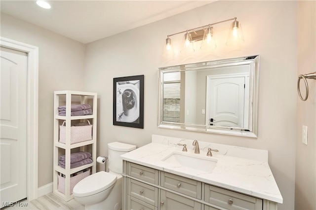 bathroom with vanity and toilet