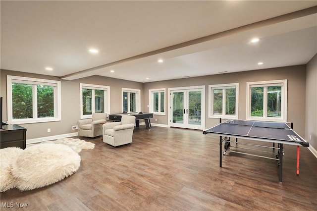 playroom featuring hardwood / wood-style floors, beam ceiling, and french doors