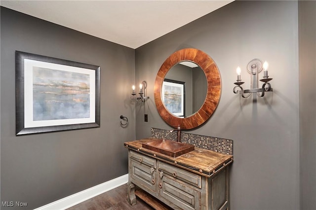 bathroom with tasteful backsplash, vanity, and hardwood / wood-style flooring