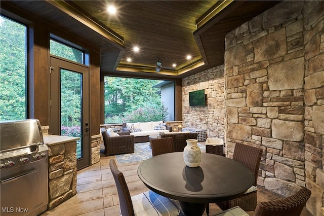 sunroom featuring wood ceiling and a tray ceiling