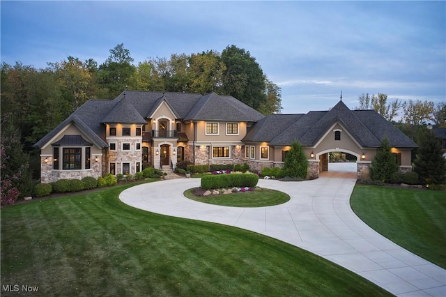 408 Sharon Falls Dr, Wadsworth, OH 44281 - french country style house featuring stucco siding, curved driveway, stone siding, and a front lawn