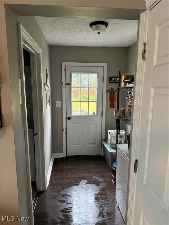 entryway featuring a textured ceiling and dark hardwood / wood-style flooring