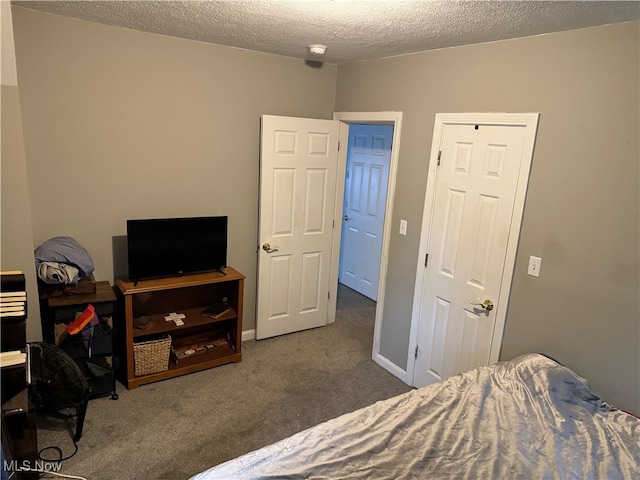 carpeted bedroom featuring a textured ceiling