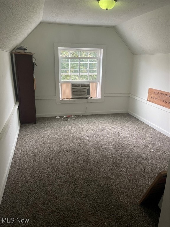 bonus room with carpet floors, cooling unit, a textured ceiling, and lofted ceiling