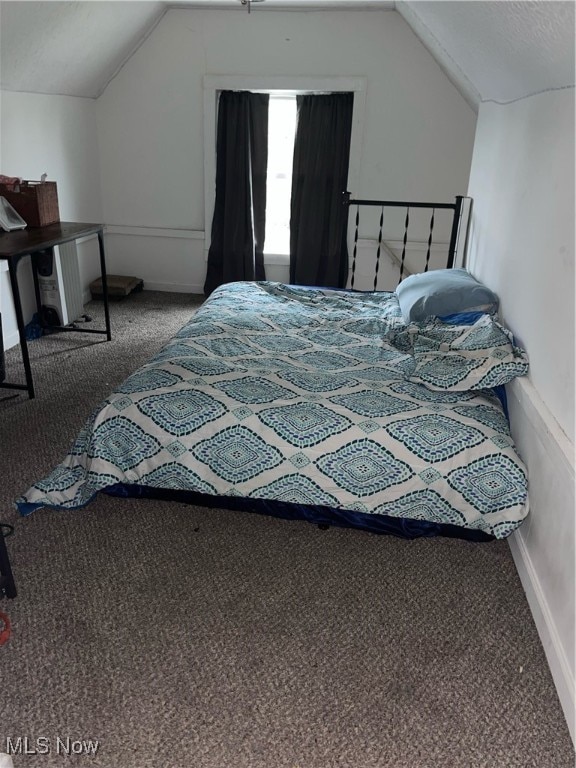 carpeted bedroom featuring vaulted ceiling