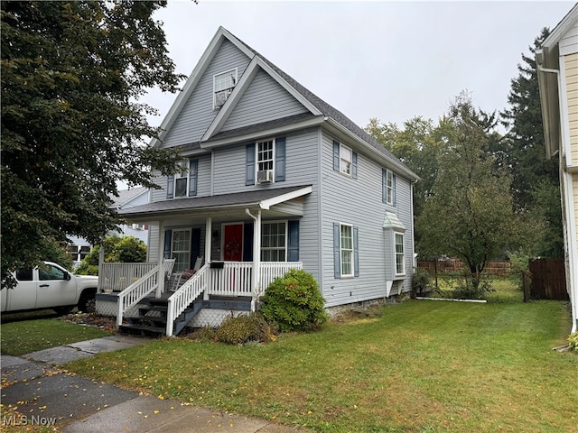 view of front of house with a front yard, cooling unit, and a porch