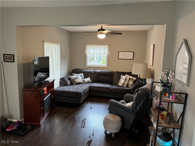 living room with dark hardwood / wood-style floors and ceiling fan